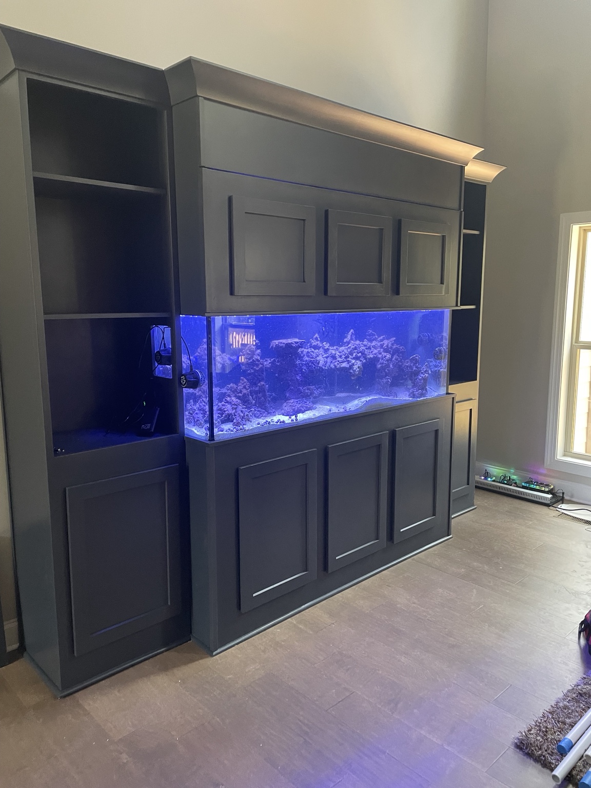 Custom dark wood aquarium cabinetry